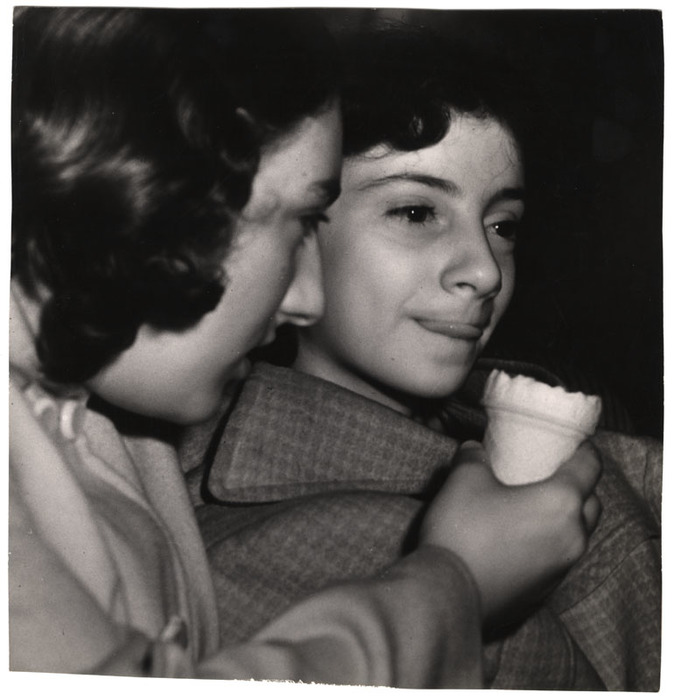[Two girls eating ice cream in movie theatre]