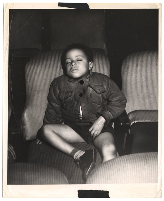 Boy sleeping in a movie theatre