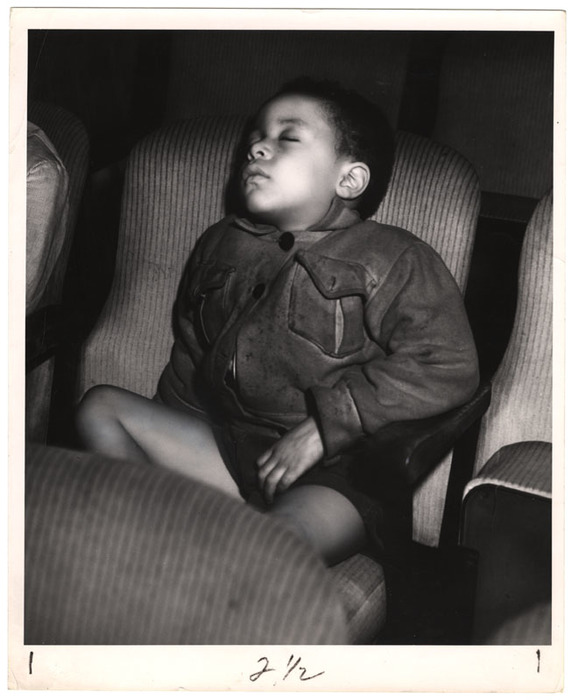 Boy sleeping in a movie theatre