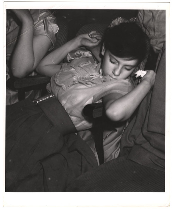 Young woman sleeping in a movie theatre