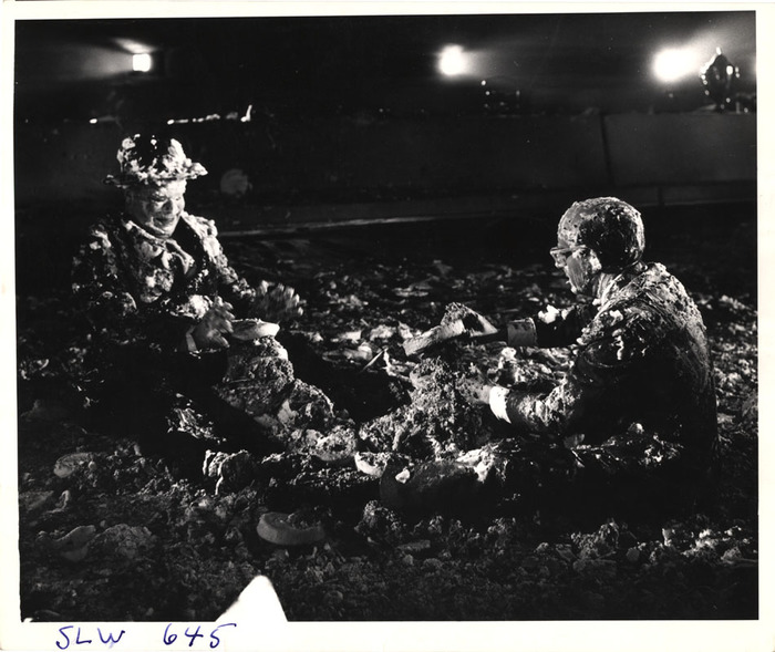 [Peter Bull as Russian Ambassador Alexi de Sadesky and Peter Sellers as American President Merkin Muffley after cream pie fight in the War Room on the set of "Dr. Strangelove or: How I Learned to Stop Worrying and Love the Bomb"]