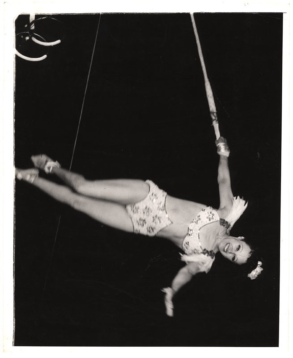 Acrobat hanging on a rope
