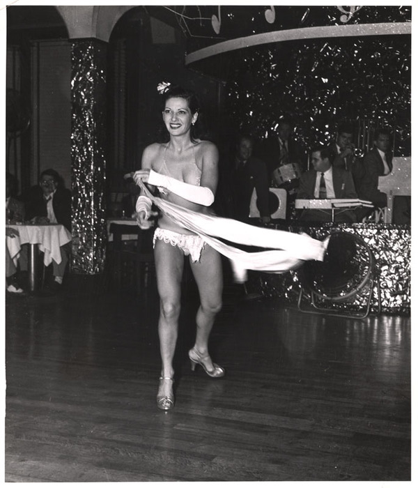 Showgirl dancing in front of band
