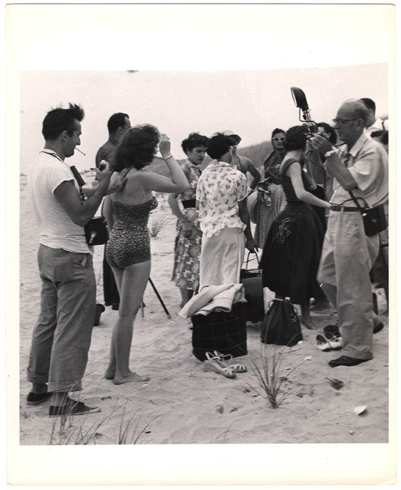 Models and photographs on the beach