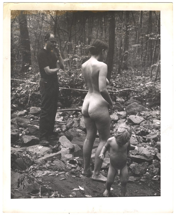 Woman and child nudists and nonnude man in the woods