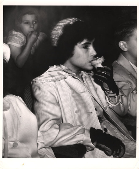 Girl eating ice cream in movie theatre
