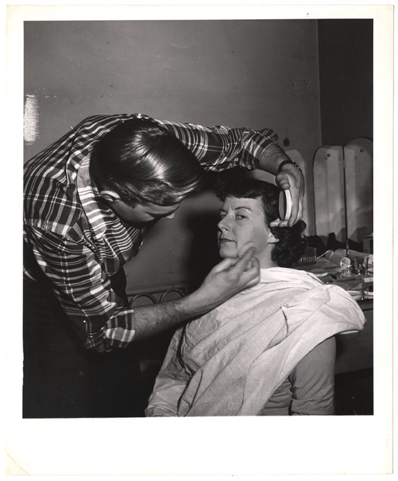 Television talk show host receiving makeup