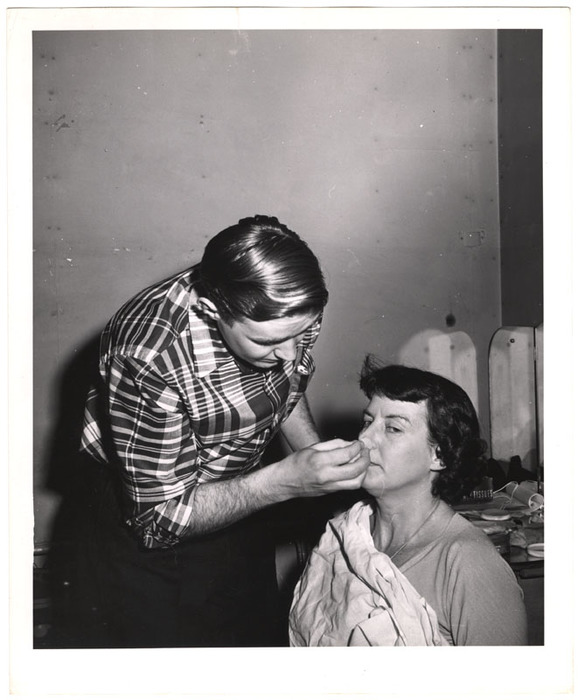 Television talk show host receiving makeup