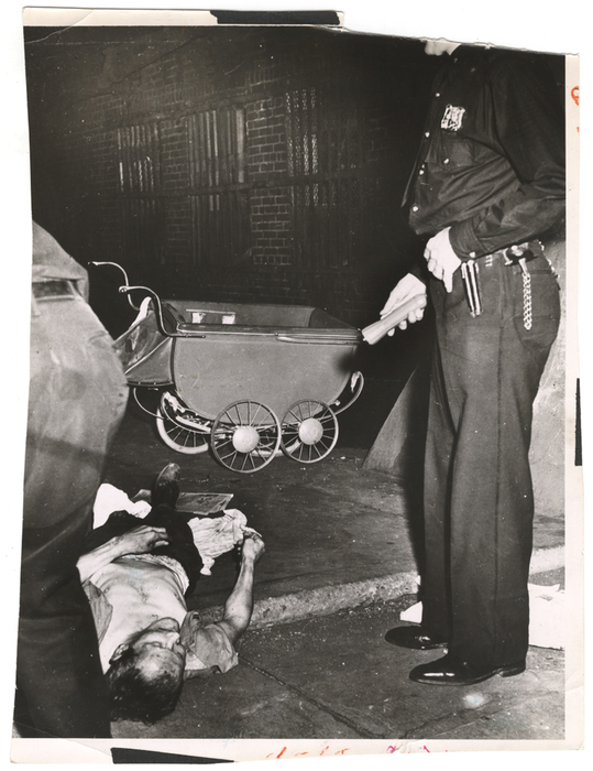 [Police officer shining flashlight on murder victim]