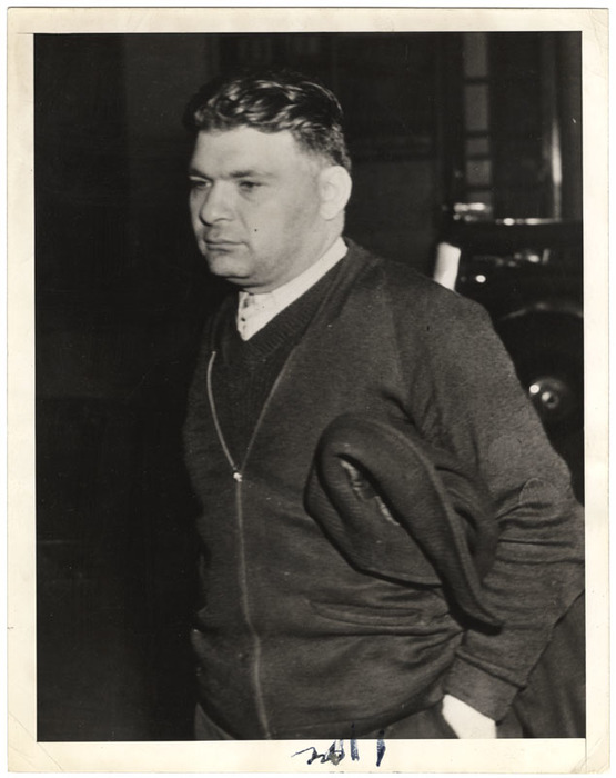 Man with coat under his arm