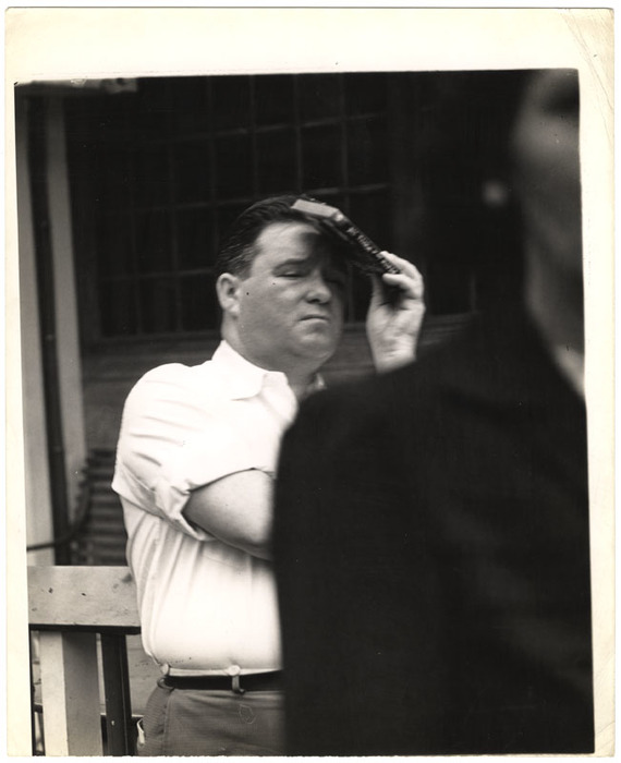 Man holding book to his head