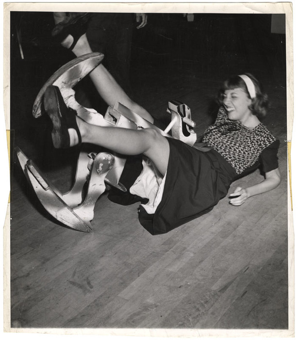 Woman laughing after having fallen off a toy horse