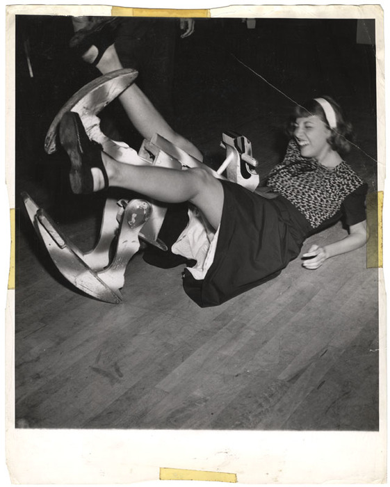 Woman laughing after having fallen off a toy horse