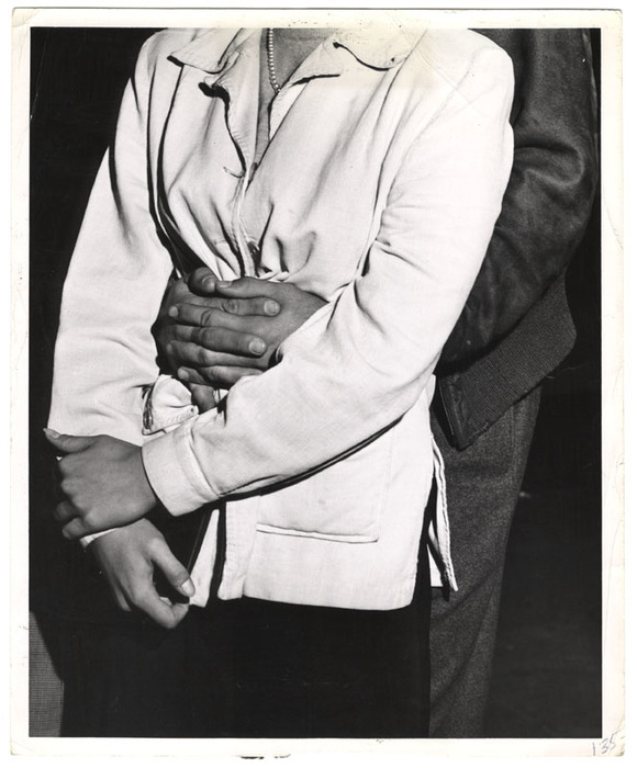 Man's arms around a woman's waist