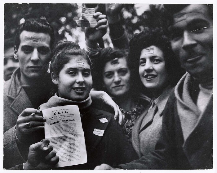 [Men and women with markings on foreheads at communist rally protesting General Dwight D. Eisenhower's visit]