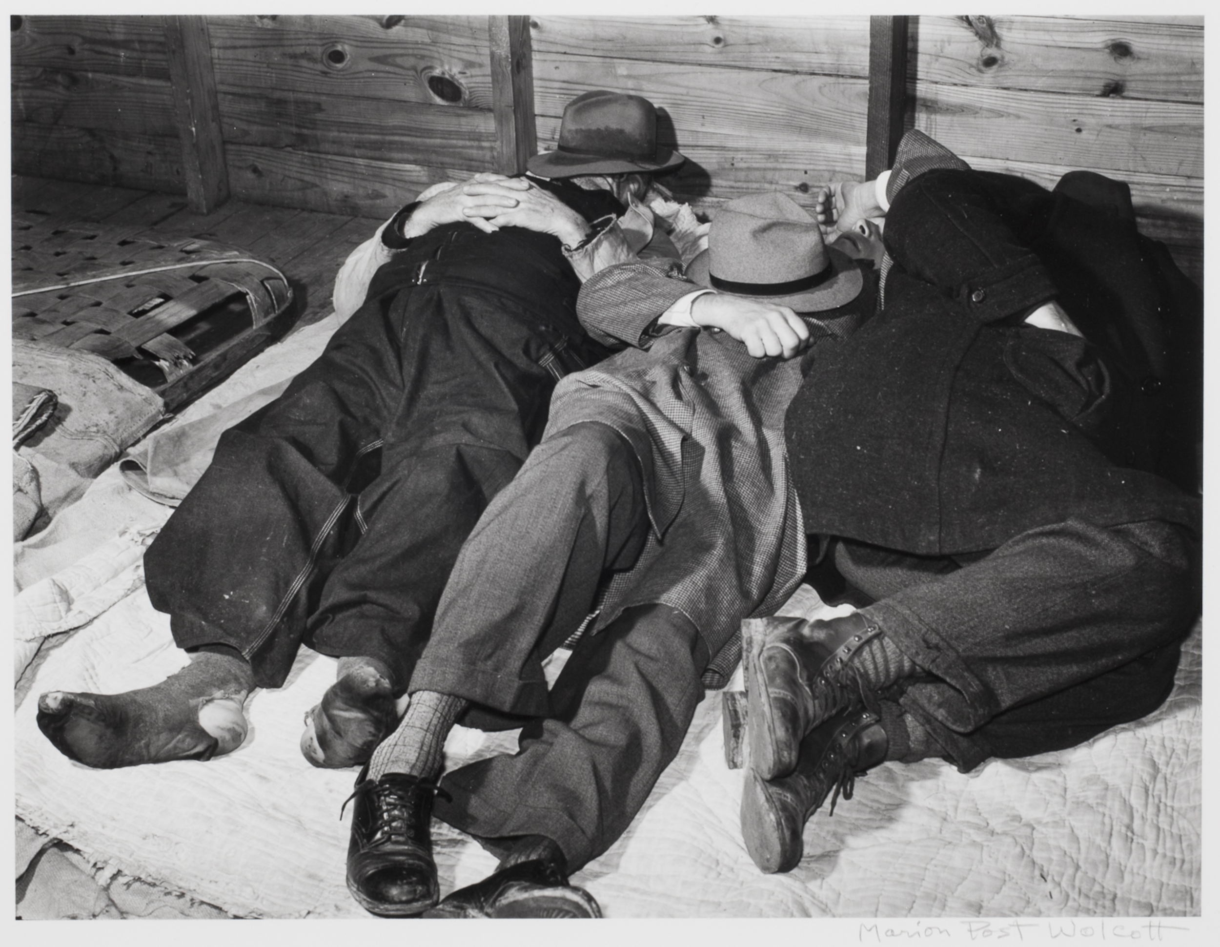 Farmers sleeping in white camp room in warehouse. They often must remain overnight or several
