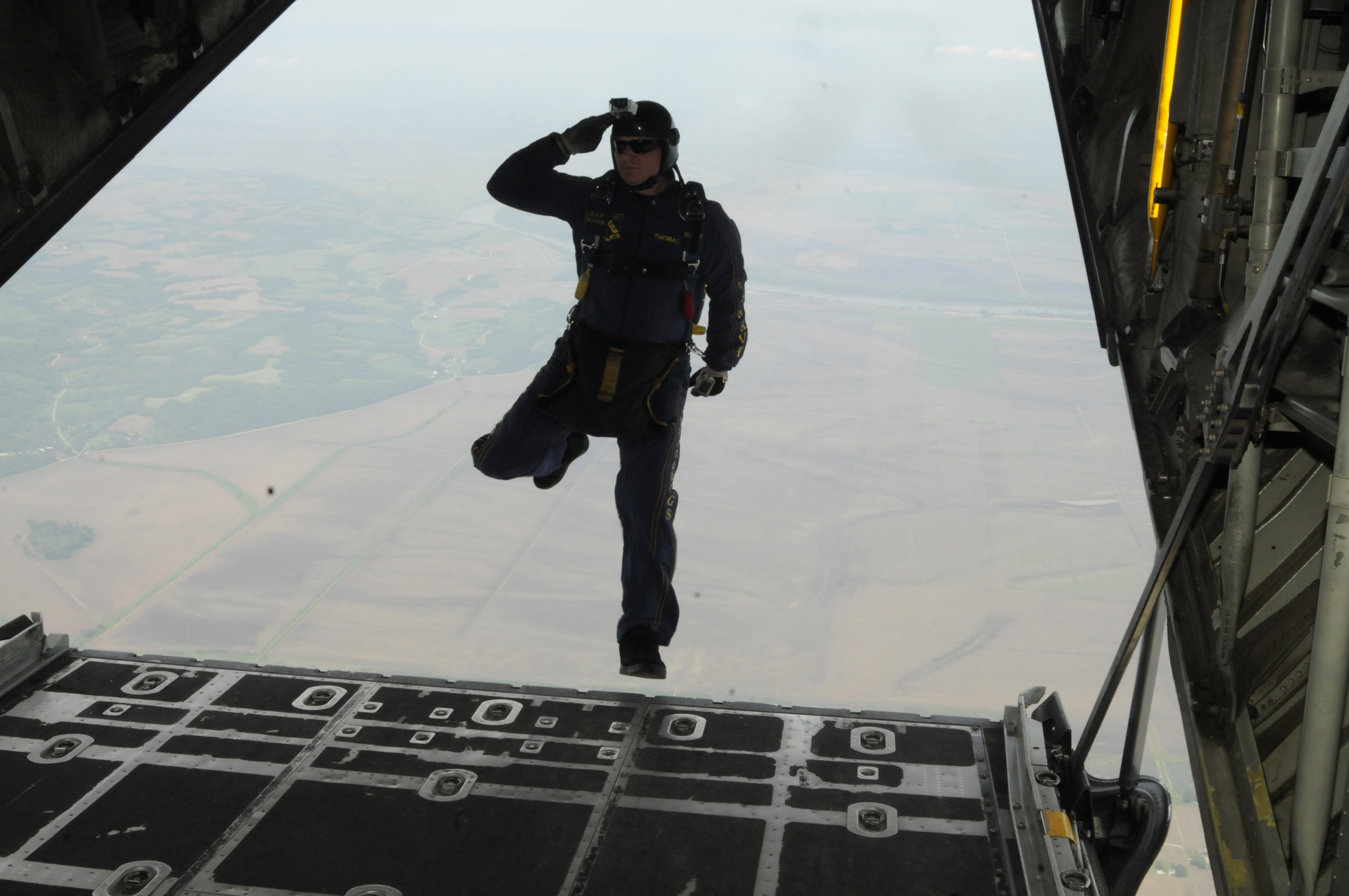 ST. JOSEPH, Mo. (May 4, 2012) Aircrew Survival Equipmentman 1st Class Thomas Kinn, assigned to the U.S. Navy parachute demonstration team, the Leap Frogs, salutes as he steps off the ramp of a C-130 Hercules aircraft assigned to the 139th Airlift Wing of Missouri Air National Guard during the Sound of Speed Air Show rehearsal at Rosecrans Memorial Airport. The Leap Frogs are based in San Diego and perform aerial parachute demonstrations in support of Naval Special Warfare and Navy recruiting. (U.S. Navy photo by Mass Communication Specialist 1st Class Michelle Turner/Released)