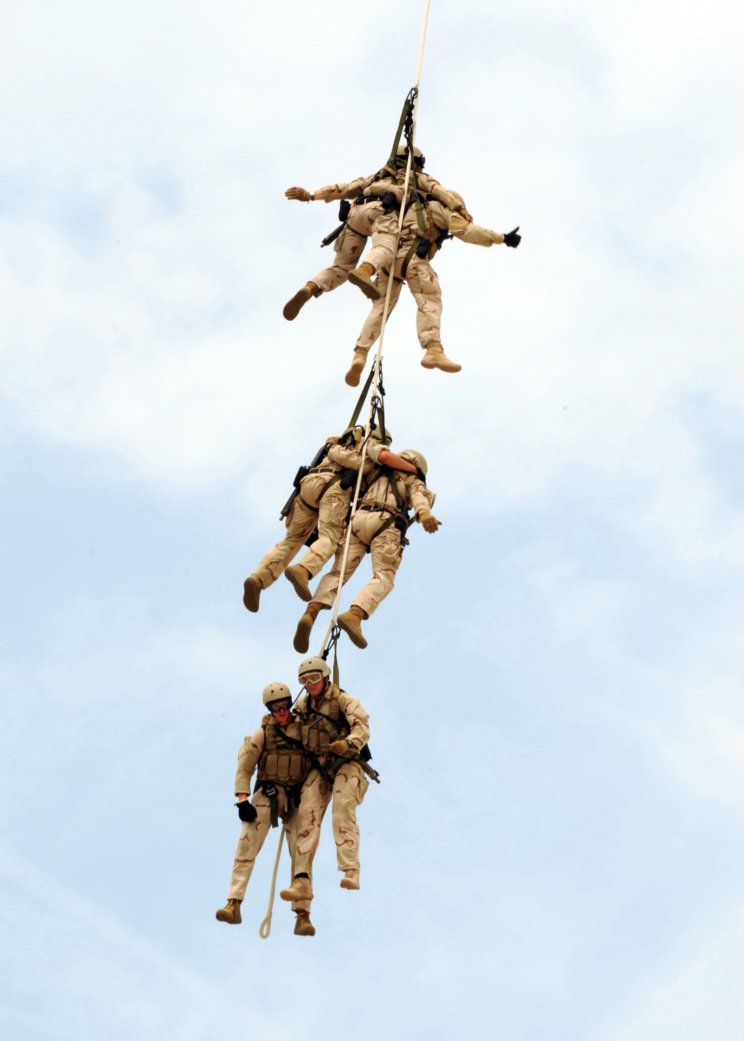 VIRGINIA BEACH, Va. (July 17, 2010) A Navy SEAL platoon hangs beneath an HH-60H Sea Hawk helicopter assigned to the Red Wolves of Helicopter Sea Combat Squadron (HSC) 84 as they perform a special patrol insertion and extraction (SPIE) exercise during a demonstration at Joint Expeditionary Base Little Creek-Fort Story. The Naval Special Warfare community displayed its capabilities as part of the 41st UDT-SEAL East Coast Reunion celebration. Events are planned throughout the weekend to honor UDT/SEAL history, heritage, and families. (U.S. Navy photo by Mass Communication Specialist 2nd Class Matt Daniels/Released)