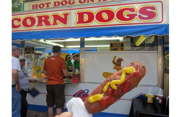 Double-bacon corndog: A hot dog is wrapped in bacon, deep fried, dipped in real bacon bit infused batter, deep fried again and served with maple syrup and more bacon bits. Photograph by: Courtesy, Calgary Stampede
