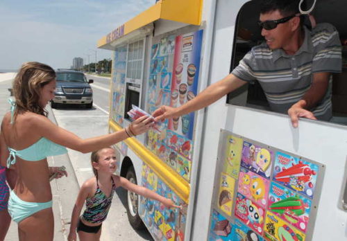 JOHN FITZHUGH/SUN HERALDMinh Nguyen of Gulfport serves ice cream to Paisley Fruge, 14, and Riley Atchison, 6, of Eunice, La., on the Beach in Biloxi. JOHN FTIZHUGH — SUN HERALD |Buy Photo