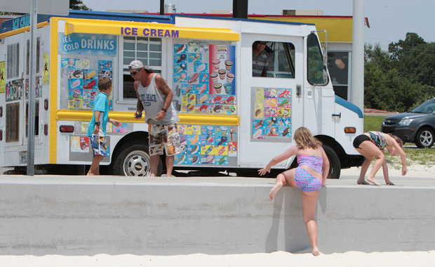 OHN FITZHUGH/SUN HERALDCustomers gather to buy ice cream from Minh Nguyen's ice cream truck on the Beach in Biloxi on Thursday, July 31, 2014. JOHN FTIZHUGH — SUN HERALD
