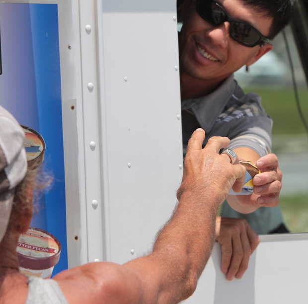 JOHN FITZHUGH/SUN HERALDMinh Nguyen of Gulfport serves ice cream to a customer on the Beach in Biloxi on Thursday, July 31, 2014. JOHN FTIZHUGH — SUN HERALD |Buy Photo