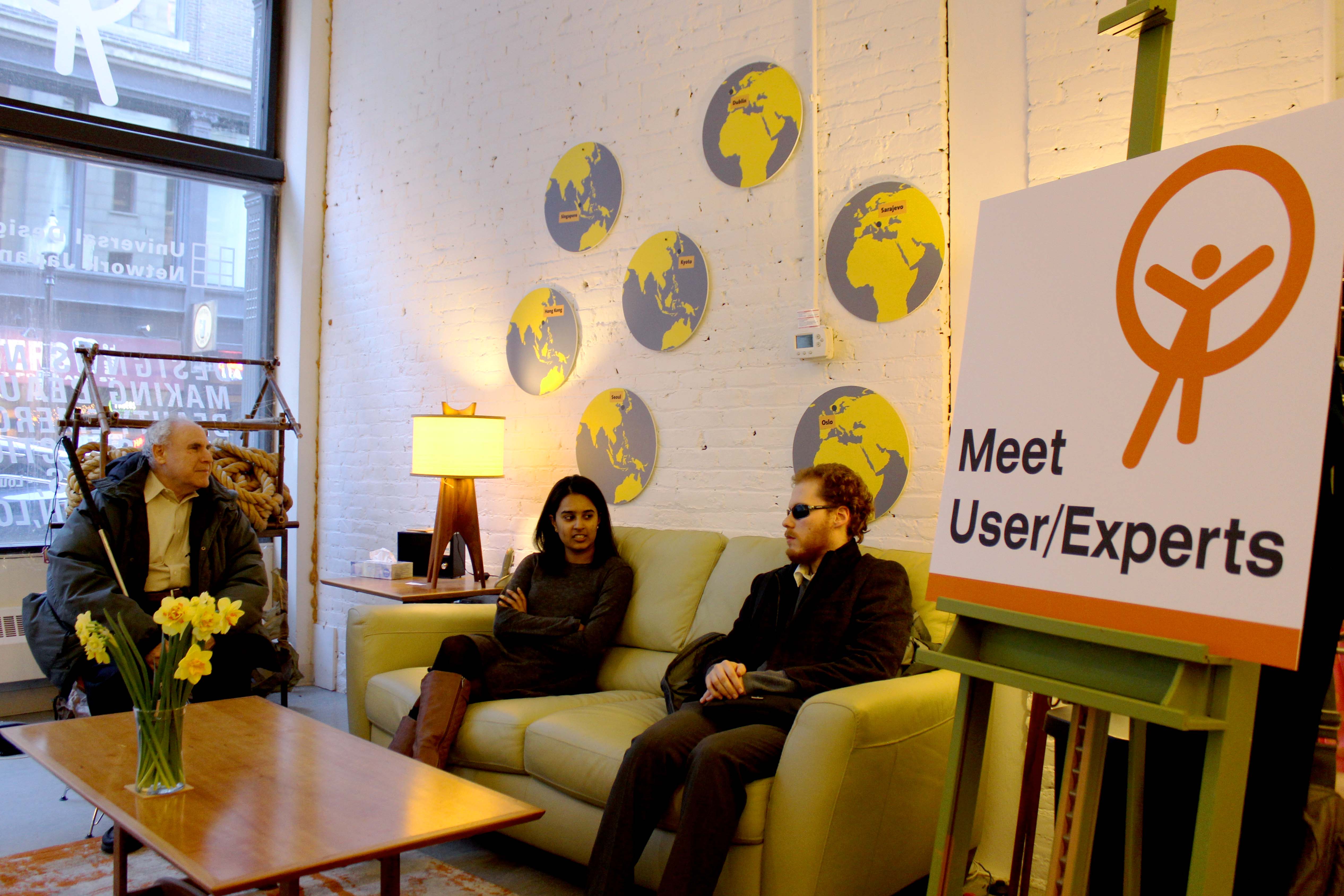 two blind users sitting on a couch