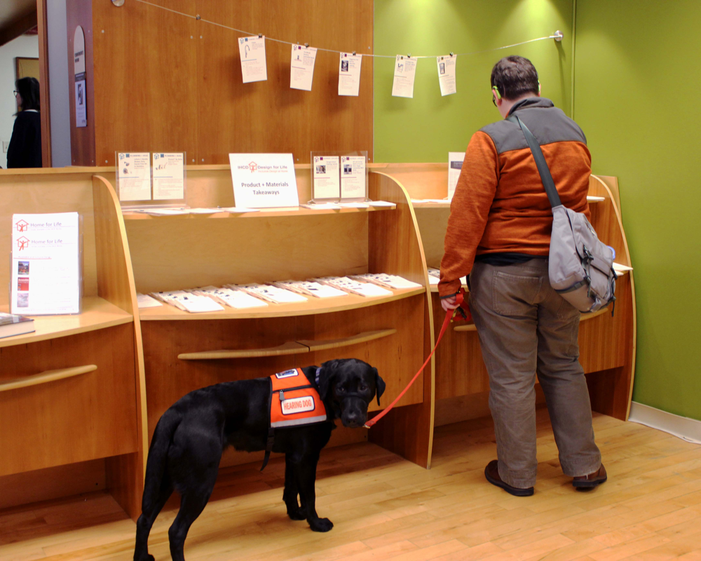 A blind man reading with his dog