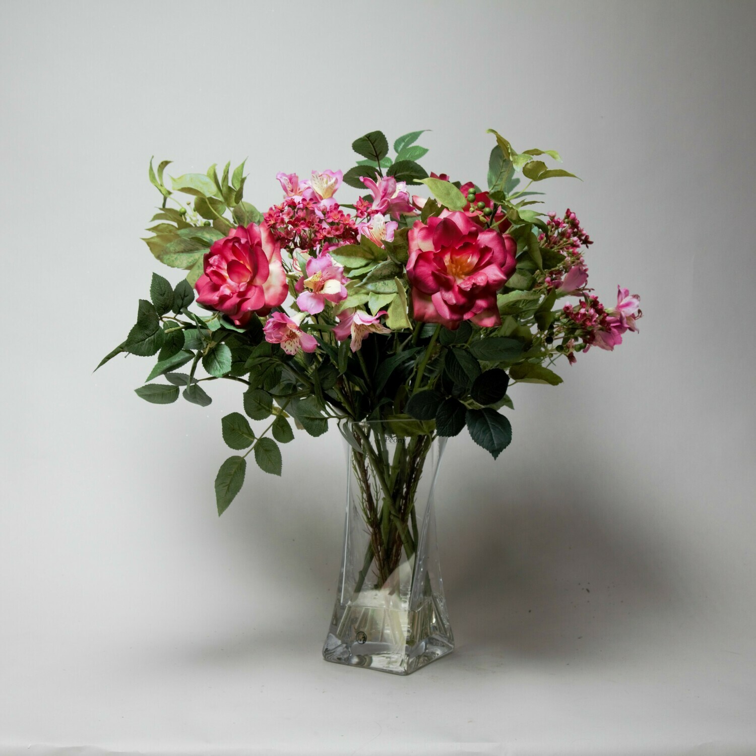 Alstroemeria, Roses and Wax flower in a twisted vase