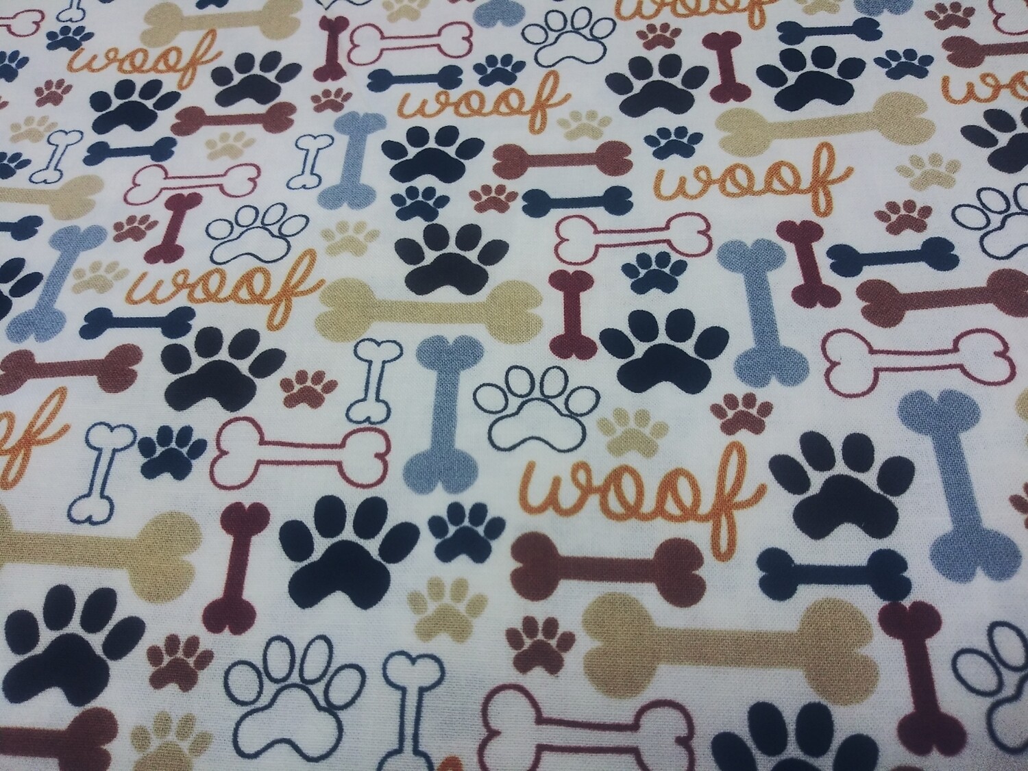 A Dog's LifeDog Bones and Paw Prints on Cream Fabric