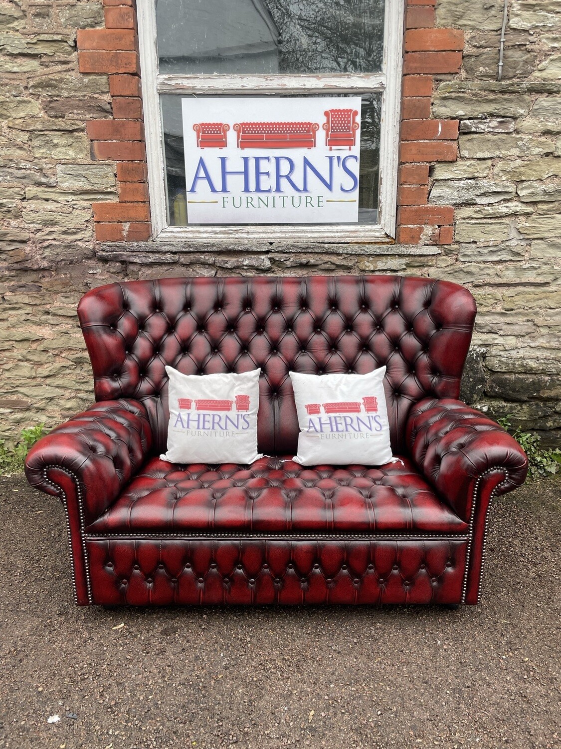 *Fully buttoned Oxblood Leather Chesterfield sofa by Saxon from the