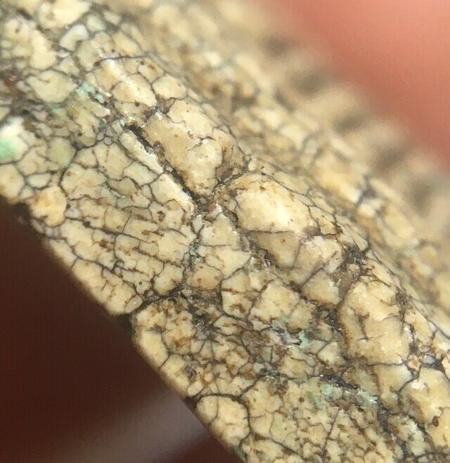 close up of muan sarn powders and aging characteristics of the edge of amulet