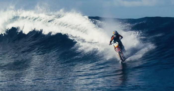 Man Rides Motorcycle On Breaking Wave