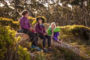 Three-Women-Hiking-in-KEEN-Versatrail-sitting-on-log
