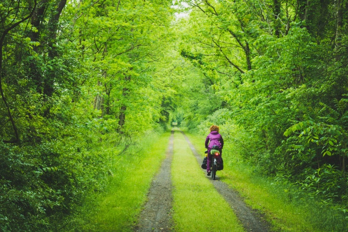 Packing It Out Abby Biking Dirt Road