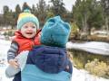 The Best Kids' Snow Gear of 2022 mom holding toddler in winter clothing