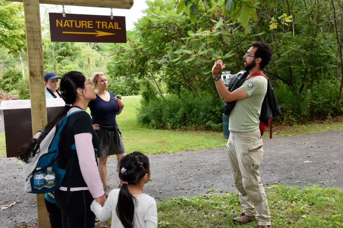 Camp Ambassador guides a nature hike through New York park