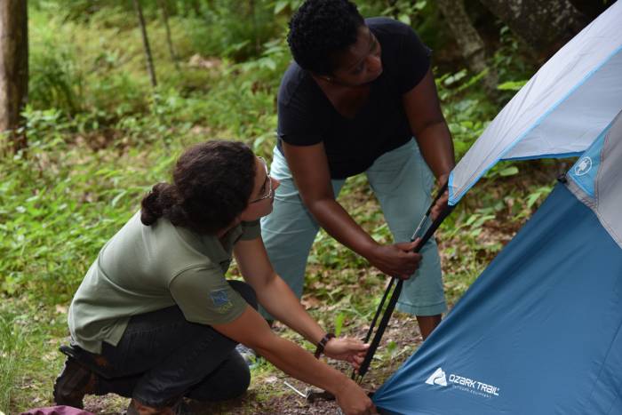 NY Camp Ambassador instructs a first-time camper how to set up a tent