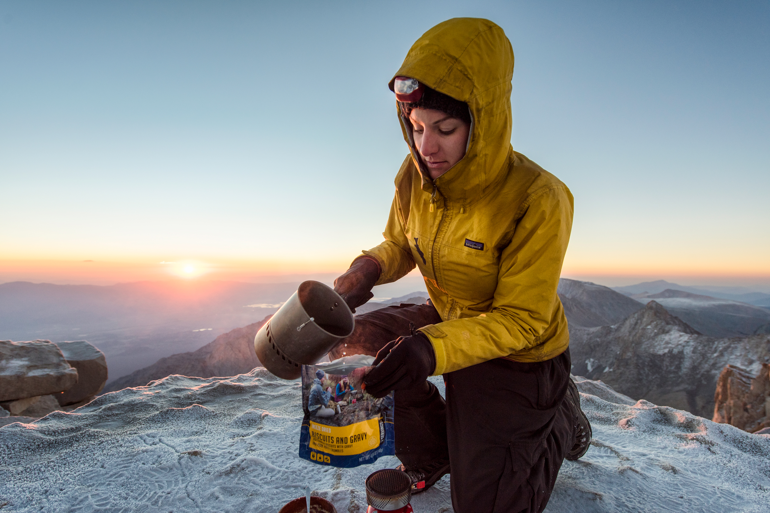 Woman pouring water into Mountain House Biscuits & Gravy meal