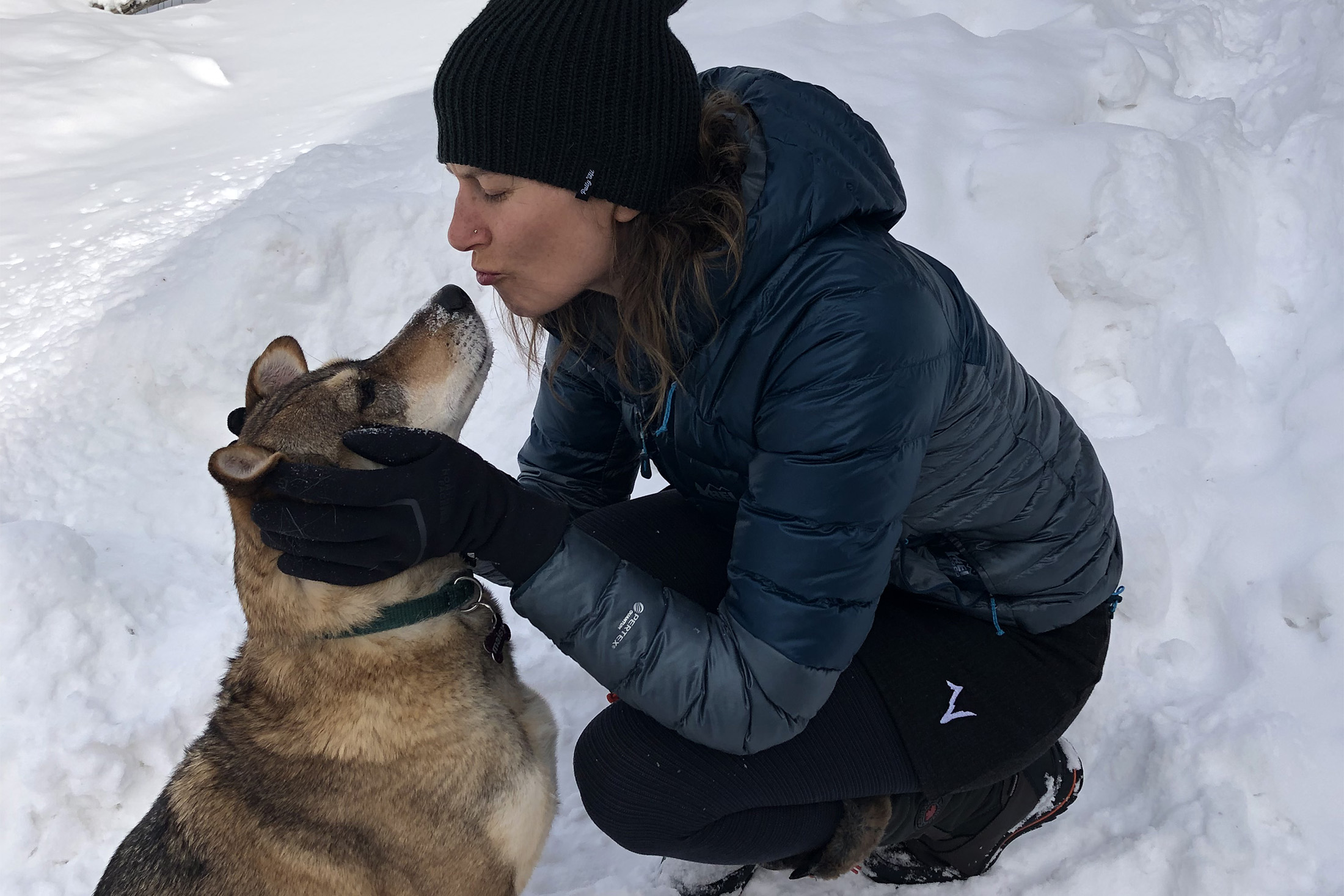 Author wearing Voormi Solstice skirt, playing with a dog