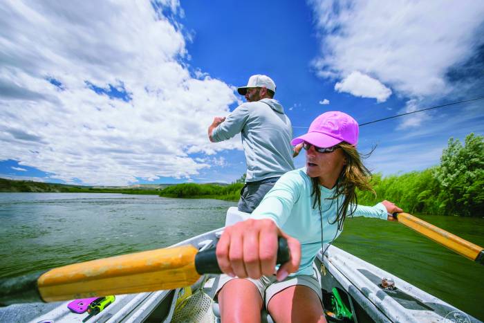 one male and female in a canoe fishing, Orvis brand gear
