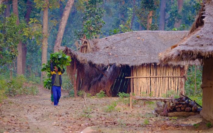 man walking through makeshift refugee village in Nepal