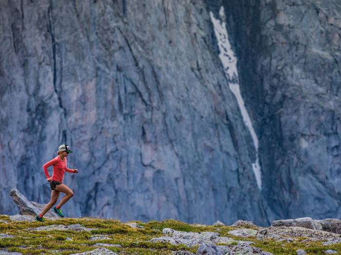 woman with hat and pink shirt running