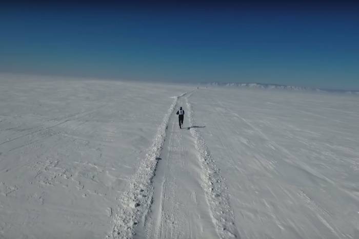 one person running over icy tundra in Lake Baikal Ice Marathon