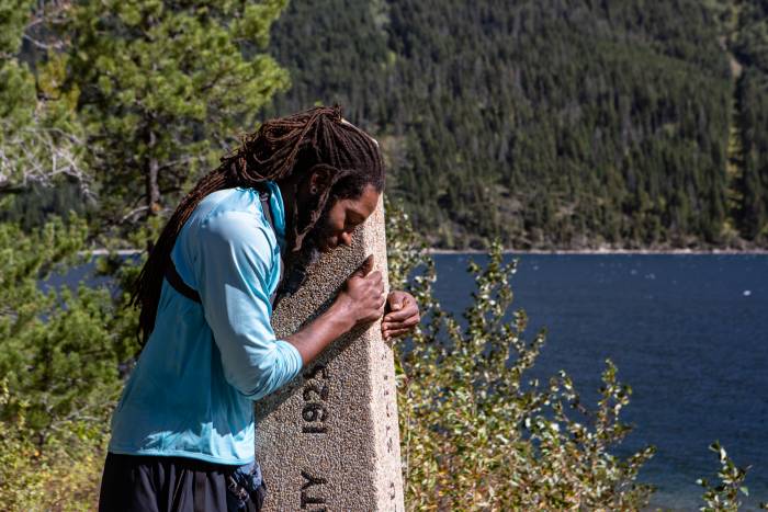 Will 'Akuna' Robinson bowing head on trail marker