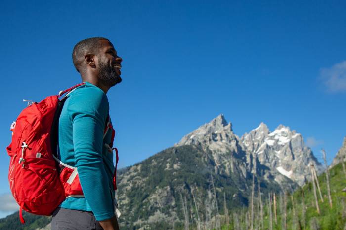African American hiker Tyrhee Moore looking up towards mountains