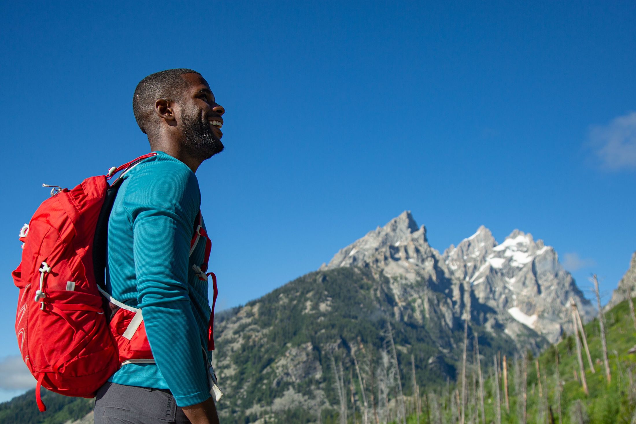African American hiker Tyrhee Moore looking up towards mountains