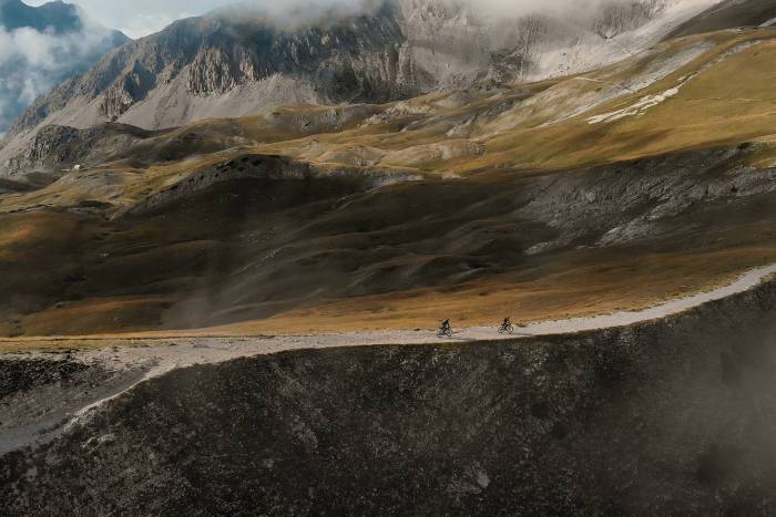cyclists far in distance along rural road