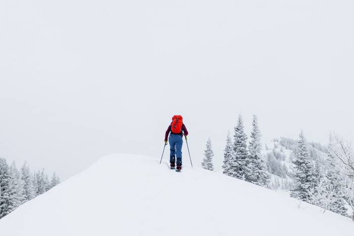 Backcountry Skier in Mountains Skinning Skiiing