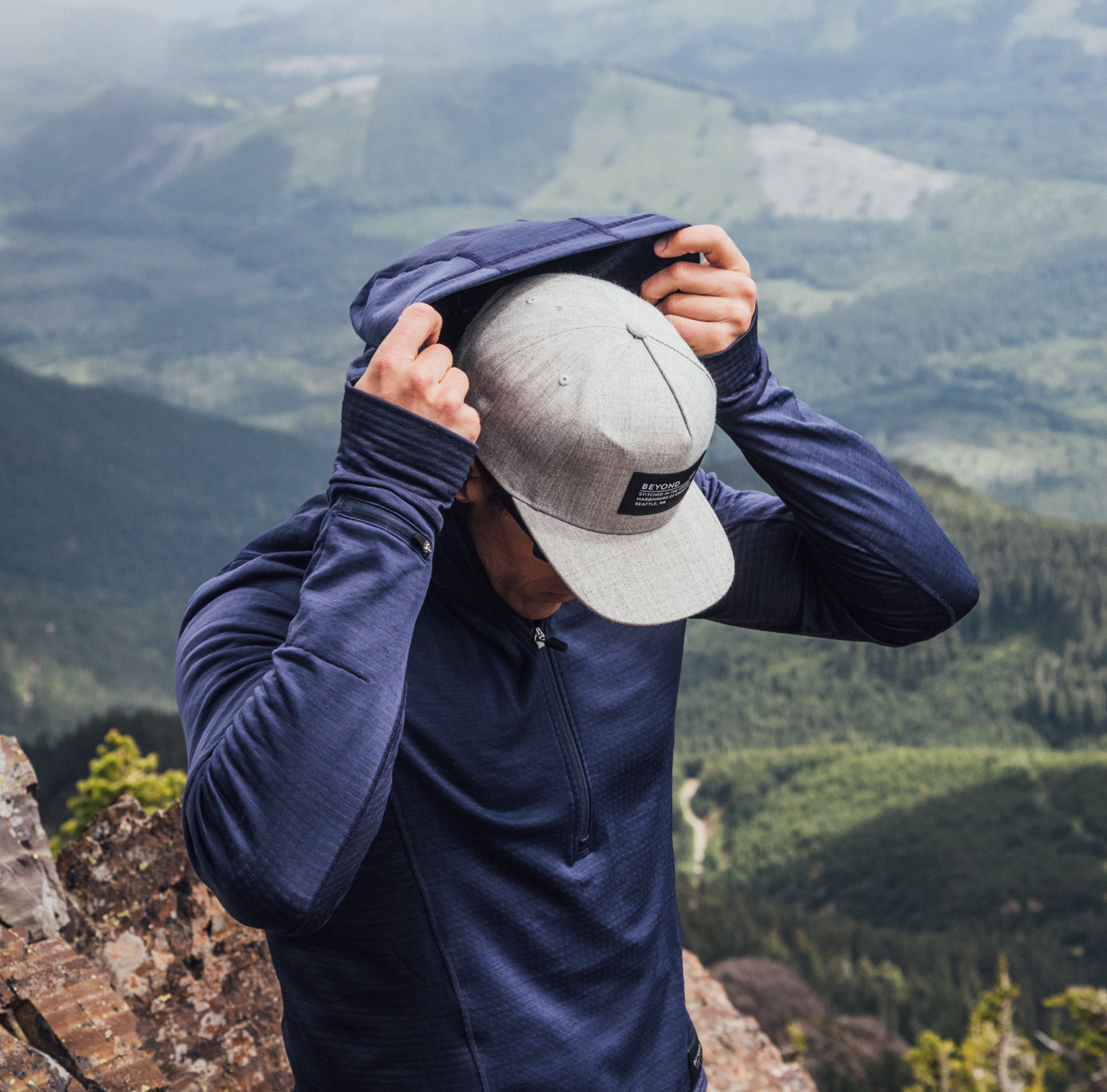 man pulling up hood on beyond clothing K2 celeris pullover over hat